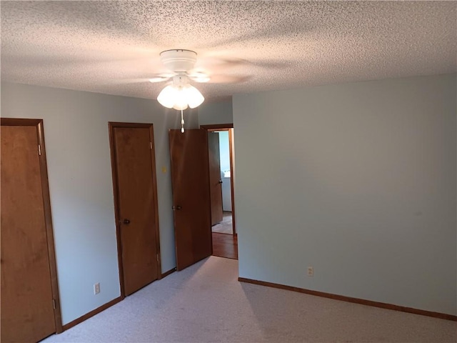1003 Freeman Ave, Berryville, AR 72616 - spare room featuring a ceiling fan, light colored carpet, a textured ceiling, and baseboards