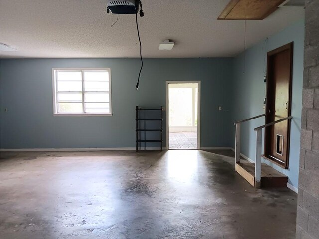 1003 Freeman Ave, Berryville, AR 72616 - garage with a garage door opener and baseboards