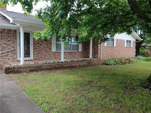 1003 Freeman Ave, Berryville, AR 72616 - view of side of property with a lawn and brick siding