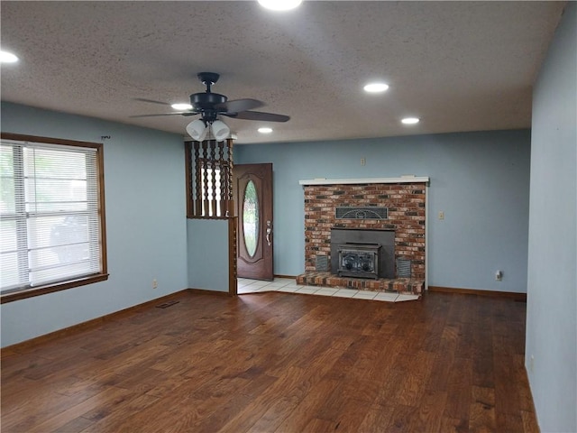 1003 Freeman Ave, Berryville, AR 72616 - unfurnished living room featuring wood finished floors, a ceiling fan, recessed lighting, a textured ceiling, and baseboards
