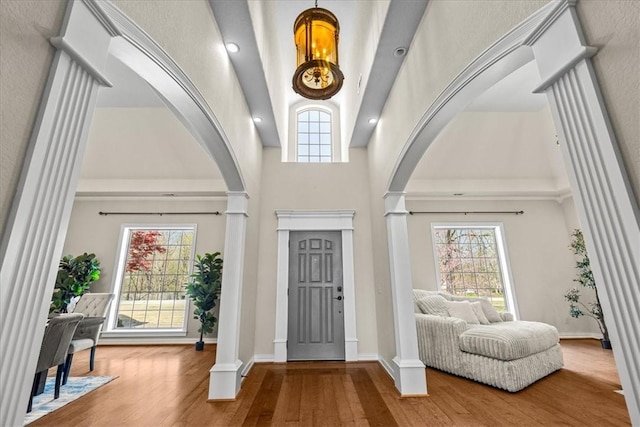 17793 Bluffview Dr, Springdale, AR 72764 - entryway featuring arched walkways, ornate columns, high vaulted ceiling, and plenty of natural light
