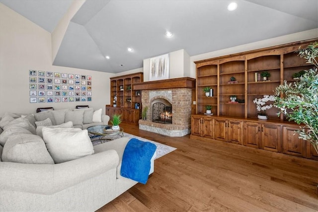 17793 Bluffview Dr, Springdale, AR 72764 - living area featuring vaulted ceiling, wood finished floors, a brick fireplace, and recessed lighting