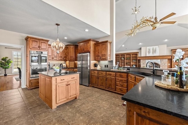 17793 Bluffview Dr, Springdale, AR 72764 - kitchen featuring stainless steel appliances, dark countertops, a chandelier, a center island with sink, and pendant lighting