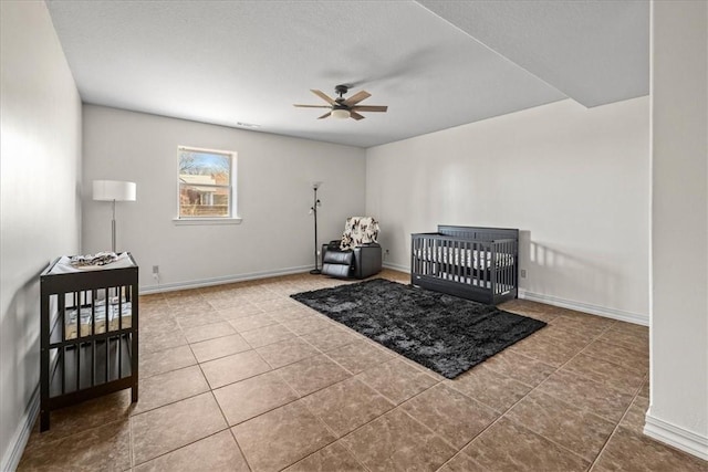 17793 Bluffview Dr, Springdale, AR 72764 - tiled bedroom featuring a ceiling fan and a crib