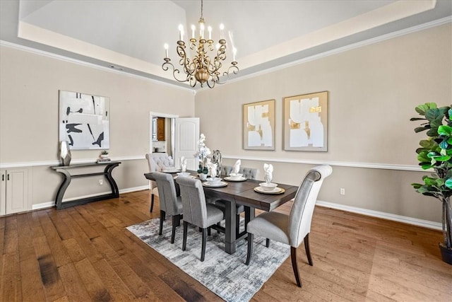 17793 Bluffview Dr, Springdale, AR 72764 - dining room with wood-type flooring, a chandelier, a raised ceiling, and ornamental molding