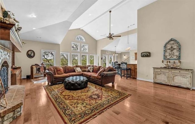 17793 Bluffview Dr, Springdale, AR 72764 - living area featuring a fireplace with raised hearth, high vaulted ceiling, wood finished floors, and ceiling fan
