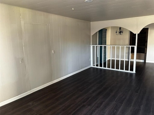 205 10th St, Danville, AR 72833 - unfurnished room with arched walkways, wood finished floors, and baseboards