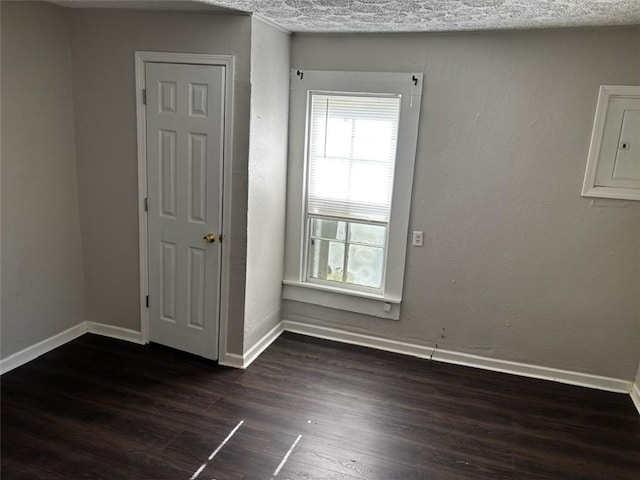205 10th St, Danville, AR 72833 - empty room with wood finished floors and baseboards