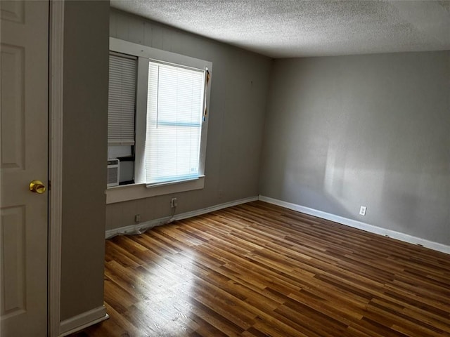 205 10th St, Danville, AR 72833 - spare room with wood finished floors, a textured ceiling, and baseboards