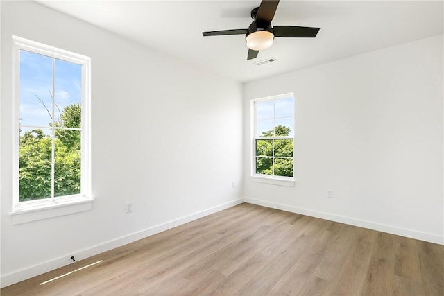 730 N 5th St, Rogers, AR 72756 - unfurnished room featuring healthy amount of natural light, light wood-style flooring, and a ceiling fan