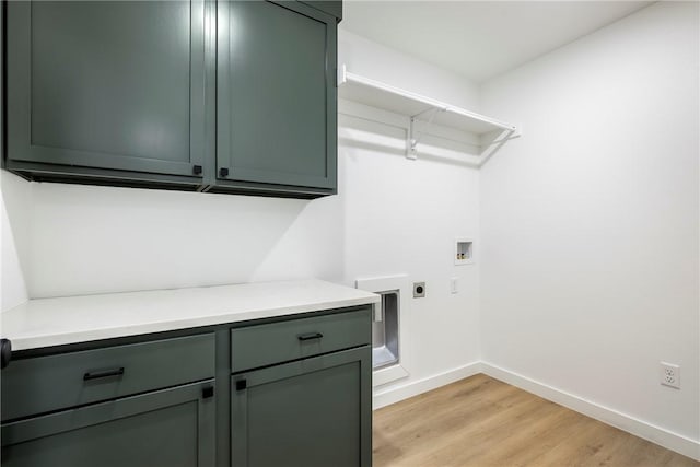 730 N 5th St, Rogers, AR 72756 - laundry room with hookup for an electric dryer, hookup for a washing machine, light wood-style flooring, and cabinet space