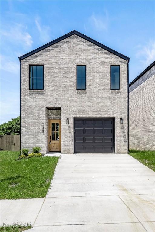 730 N 5th St, Rogers, AR 72756 - contemporary home with an attached garage, driveway, and brick siding