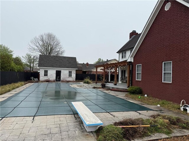 2110 W 8th St, Russellville, AR 72801 - view of swimming pool with an outbuilding, a patio area, a fenced backyard, a diving board, and a pergola