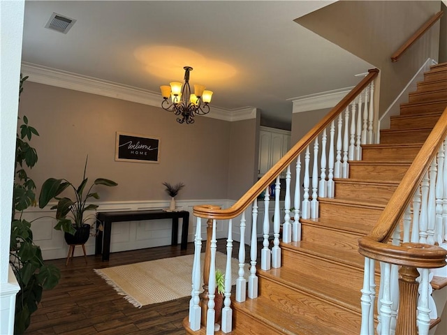 2110 W 8th St, Russellville, AR 72801 - stairs with wood finished floors, crown molding, and a chandelier
