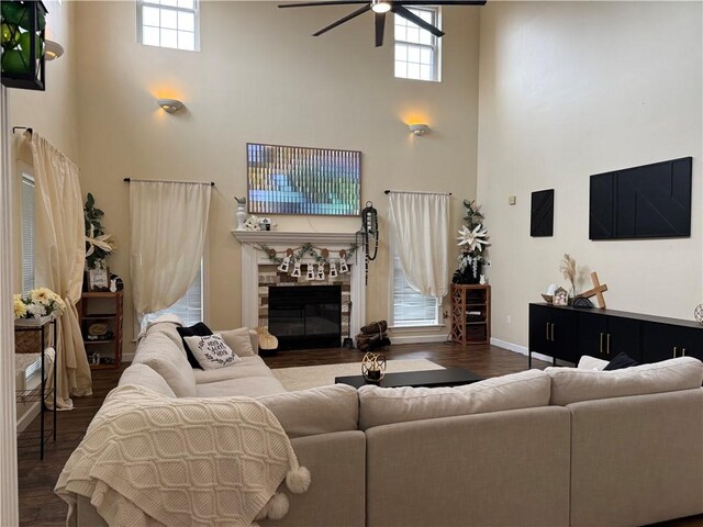 2110 W 8th St, Russellville, AR 72801 - living room with a high ceiling, a ceiling fan, wood finished floors, healthy amount of natural light, and a glass covered fireplace