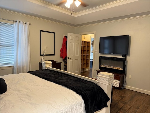 2110 W 8th St, Russellville, AR 72801 - bedroom with dark wood-type flooring, a tray ceiling, ornamental molding, baseboards, and a ceiling fan