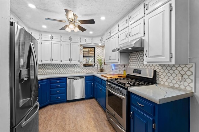 2230 Reed Ave, Springdale, AR 72764 - kitchen featuring a ceiling fan, stainless steel appliances, white cabinets, under cabinet range hood, and blue cabinets