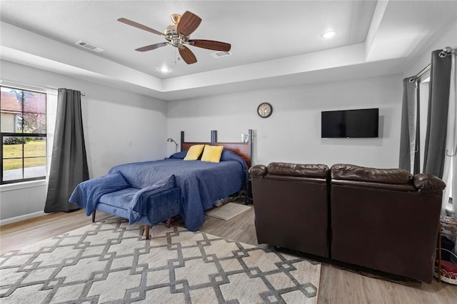 2230 Reed Ave, Springdale, AR 72764 - bedroom with a ceiling fan, a raised ceiling, light wood finished floors, and visible vents