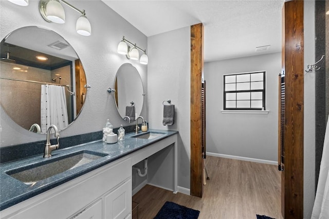2230 Reed Ave, Springdale, AR 72764 - bathroom with wood finished floors, a shower with curtain, and a sink