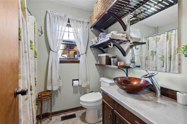 2230 Reed Ave, Springdale, AR 72764 - full bathroom featuring vanity, toilet, baseboards, and visible vents