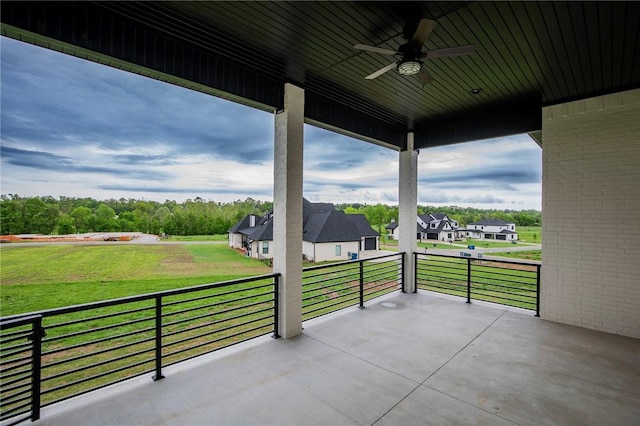 view of patio / terrace featuring a ceiling fan, a balcony, and a residential view