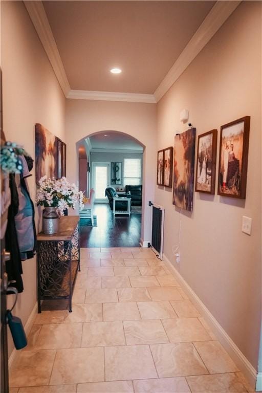 hall with baseboards, recessed lighting, arched walkways, and ornamental molding