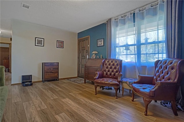 1812 E 12th St, Russellville, AR 72802 - living area with wood finished floors, a textured ceiling, and baseboards