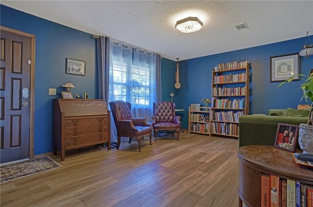 1812 E 12th St, Russellville, AR 72802 - living area featuring a textured ceiling and wood finished floors