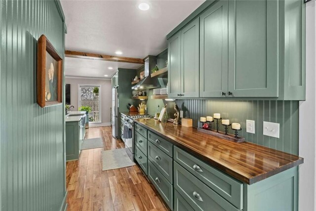 1617 N Applebury Dr, Fayetteville, AR 72701 - kitchen with light wood-type flooring, stainless steel appliances, butcher block counters, green cabinetry, and a sink
