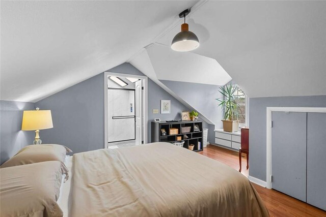1617 N Applebury Dr, Fayetteville, AR 72701 - bedroom featuring vaulted ceiling and wood finished floors