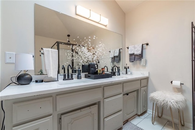 full bath featuring a shower stall, double vanity, and a sink