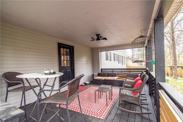 deck with outdoor lounge area and ceiling fan