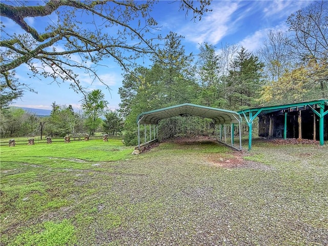view of green lawn with a carport