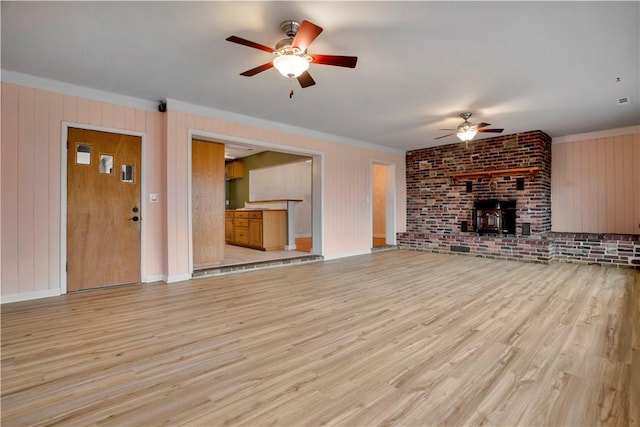 203 N Oklahoma Way, Fayetteville, AR 72701 - unfurnished living room with a ceiling fan, crown molding, light wood-type flooring, baseboards, and brick wall