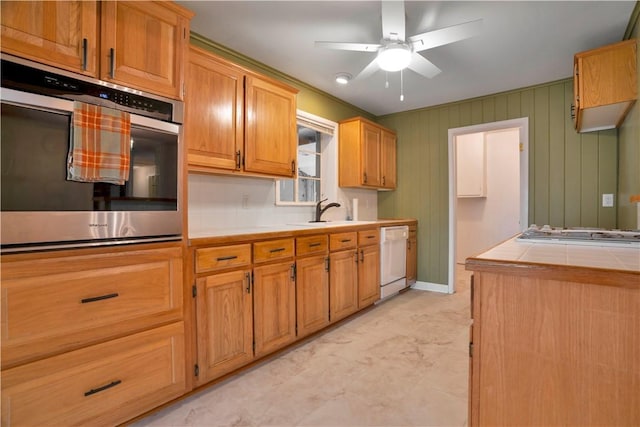 203 N Oklahoma Way, Fayetteville, AR 72701 - kitchen featuring dishwasher, stainless steel oven, a sink, ceiling fan, and tile counters
