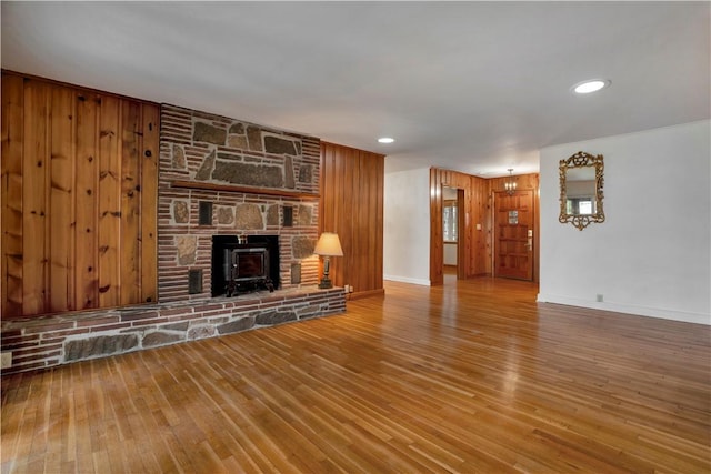 203 N Oklahoma Way, Fayetteville, AR 72701 - unfurnished living room with wood finished floors, baseboards, recessed lighting, and a wood stove
