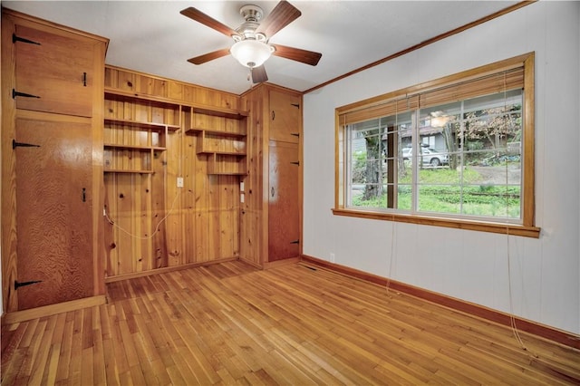203 N Oklahoma Way, Fayetteville, AR 72701 - spare room with hardwood / wood-style flooring, baseboards, ornamental molding, a ceiling fan, and wooden walls