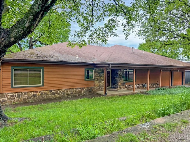 203 N Oklahoma Way, Fayetteville, AR 72701 - rear view of property with a patio, stone siding, and a yard