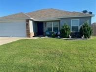 817 Evans Cir, Bentonville, AR 72713 - view of front of home with an attached garage, driveway, and a front yard