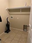 817 Evans Cir, Bentonville, AR 72713 - laundry area featuring laundry area, hookup for a washing machine, and tile patterned flooring