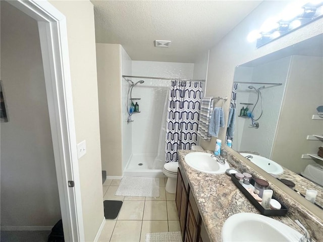 817 Evans Cir, Bentonville, AR 72713 - bathroom featuring a sink, tile patterned floors, and a textured ceiling