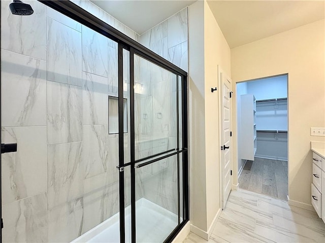 4903 SW Wakanda St, Bentonville, AR 72713 - full bath featuring a shower stall, vanity, a spacious closet, and marble look tiles