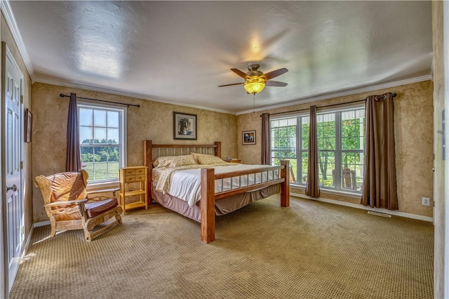 bedroom featuring a ceiling fan, light colored carpet, baseboards, and ornamental molding