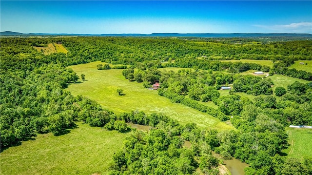 birds eye view of property featuring a view of trees