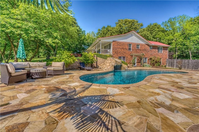 pool featuring outdoor lounge area, a patio, and fence