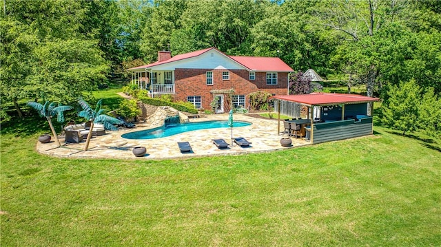 pool featuring a patio area and a yard
