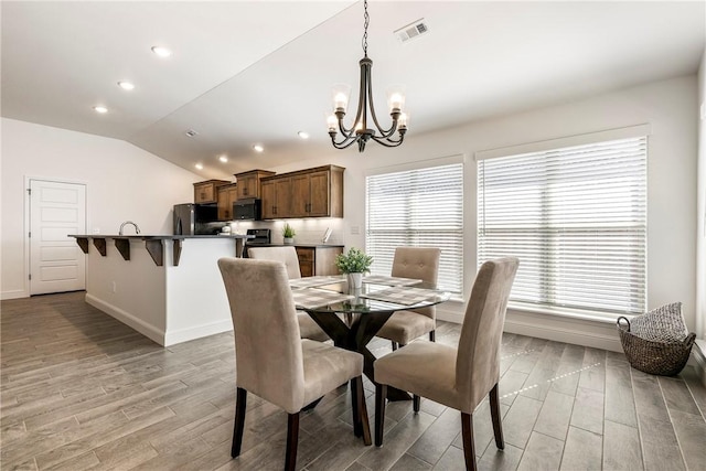 2405 Armstrong Ln, Pea Ridge, AR 72751 - dining area featuring light wood-type flooring, a chandelier, baseboards, recessed lighting, and vaulted ceiling