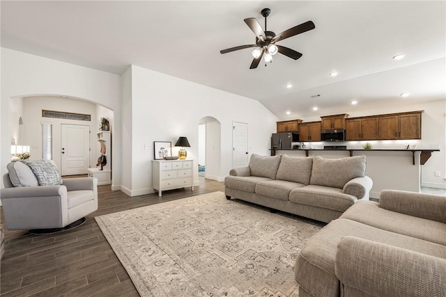 2405 Armstrong Ln, Pea Ridge, AR 72751 - living room featuring arched walkways, ceiling fan, baseboards, dark wood finished floors, and lofted ceiling