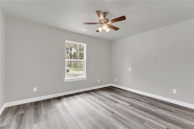 1328 San Miguel Dr, Springdale, AR 72762 - spare room featuring ceiling fan, wood finished floors, and baseboards