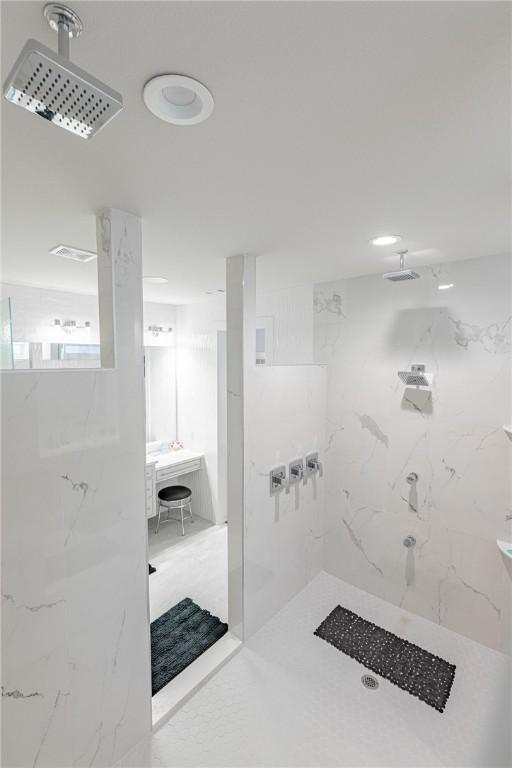 full bathroom featuring a marble finish shower